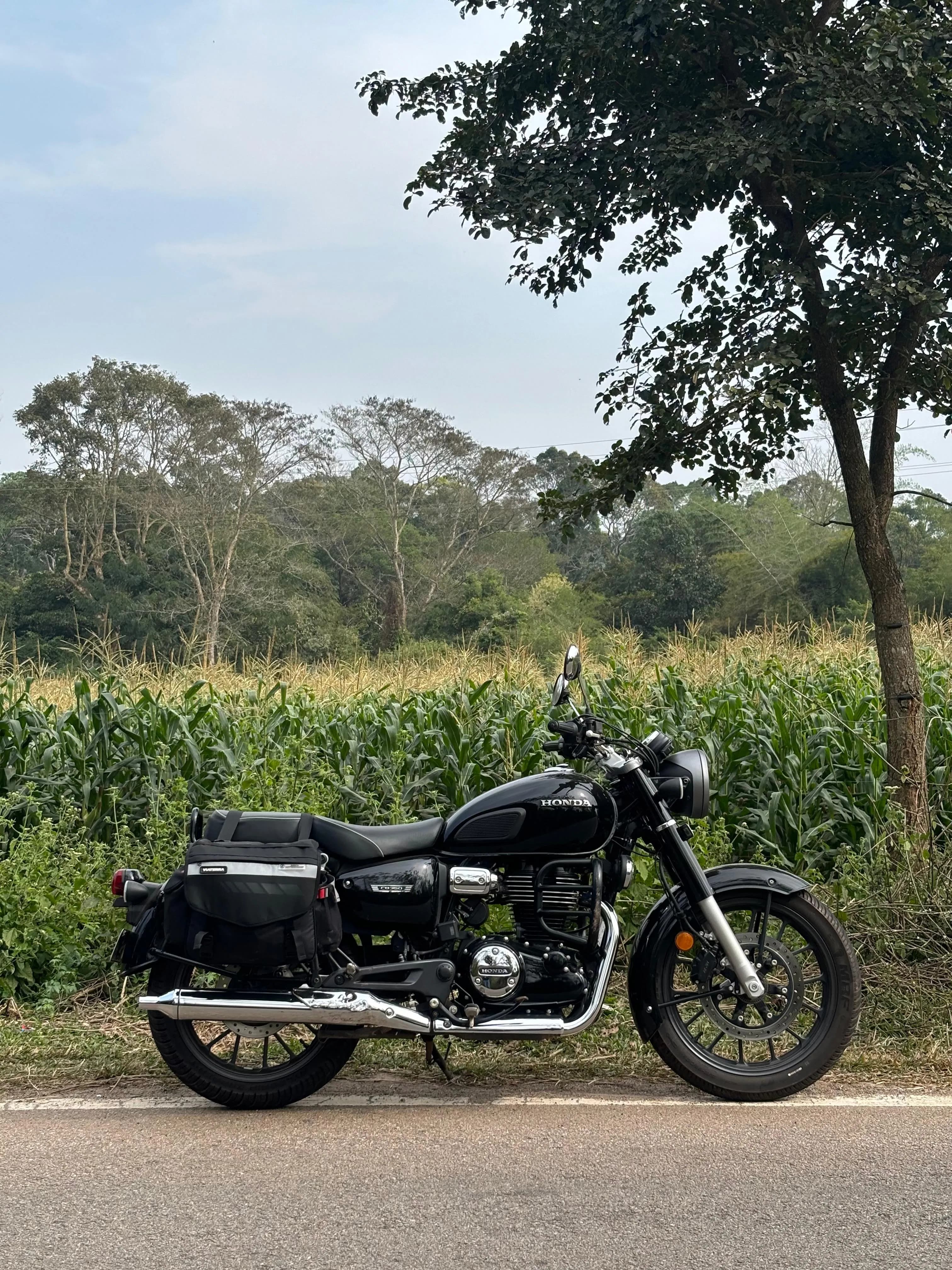 Akhil’s black Honda motorcycle parked beside a field